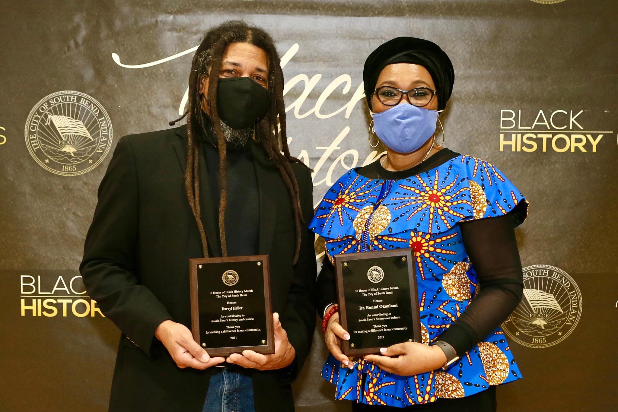 Dr. Heller and Dr. Okanlami holding plaques honoring them for service and leadership, for Black History Month